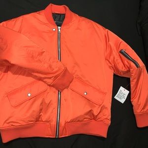 Men’s Asos bomber jacket in orange. Size XL. Has an oversized fit.
